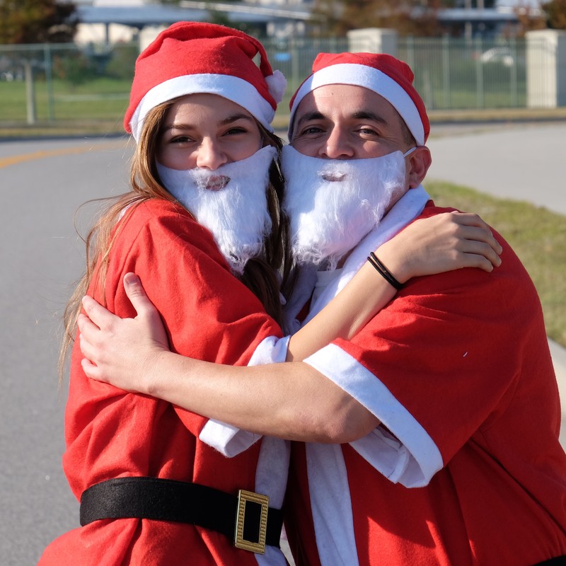 Two runners in Santa costumes at the 2016 Viera #RunRunSanta one miler race.