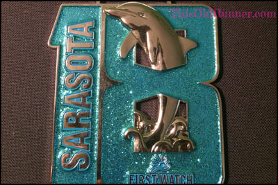 4 and a half inch finisher medal for First Watch Sarasota Half Marathon