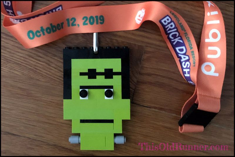 Finisher medal for the Brick Dash 5K is a Frankenstein head made of legos.