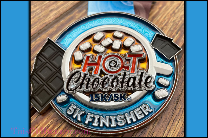 Close up view of the 2021-2022 Hot Chocolate 5K Finisher Medal.