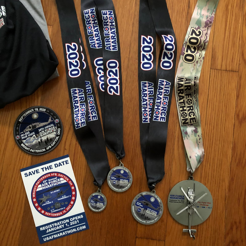 Two shirts, a patch, and 4 medals for completing the Air Force Marathon Half Marathon Challenge.