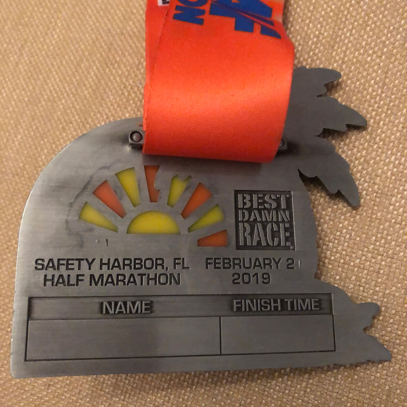 2019 medals from Best Damn Race half in Safety Harbor, FL.