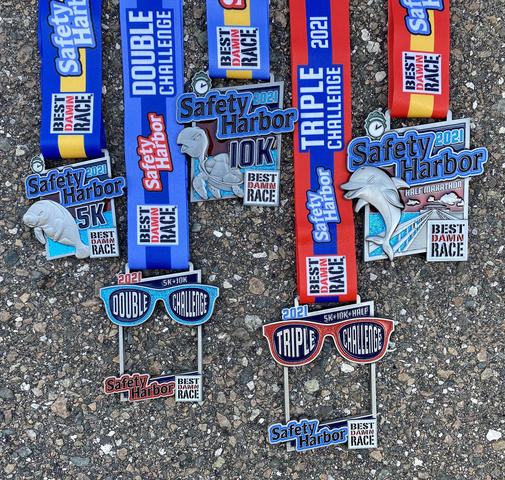Front view of all the Best Damn Race Safety Harbor Medals in 2021 includes a Double and Triple Challenge.
