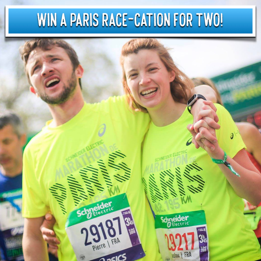 A smiling man and woman finish the Paris Marathon.