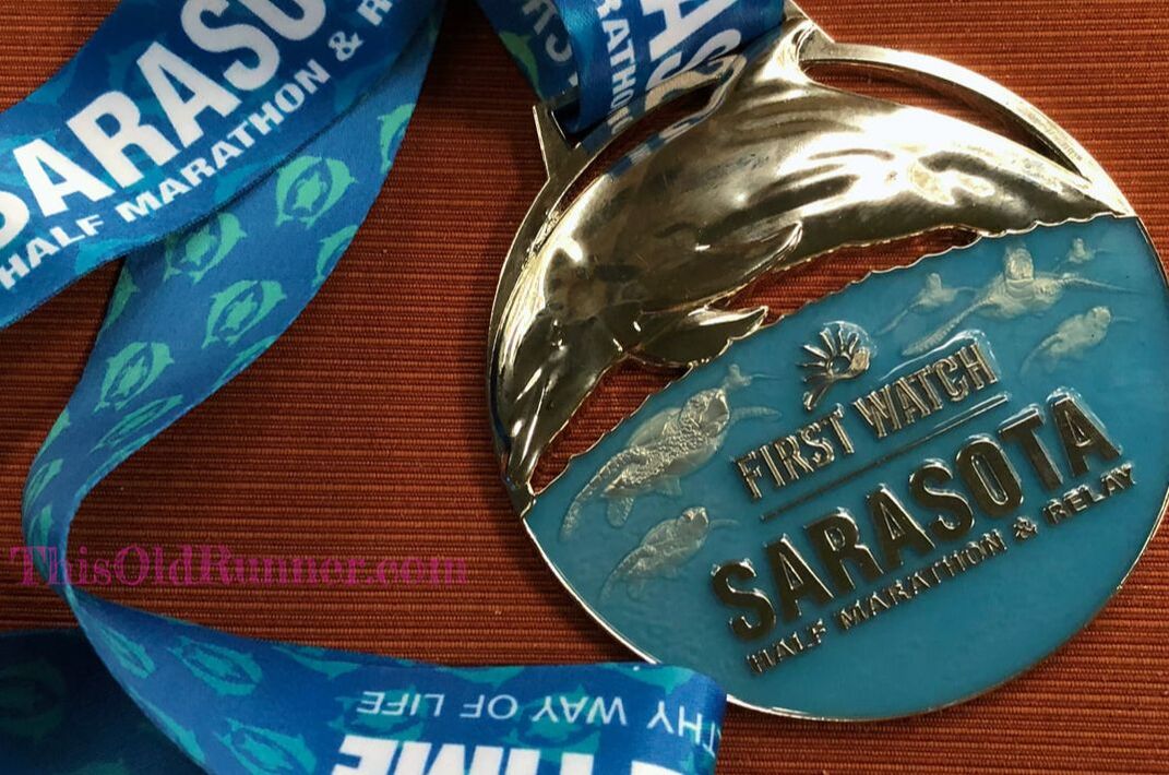 Half marathon finisher medal for First Watch Sarasota half marathon.