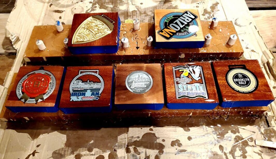 View of 7 race medals made into Handcrafted Coasters.