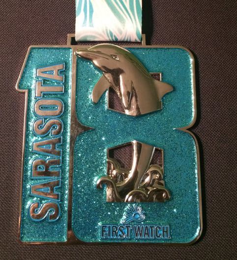 Picture of Sarasota Half Marathon Medal and This Old Runner.