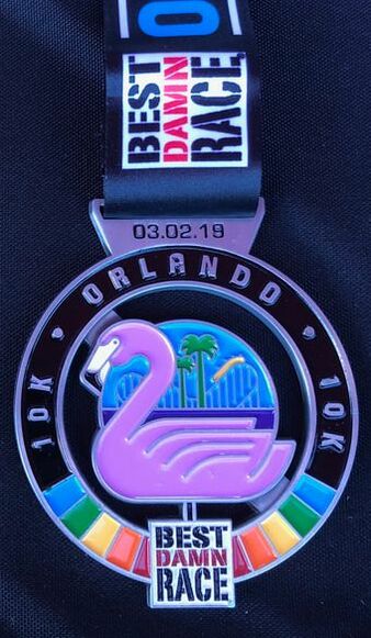 10K medal for Best Damn Race Orlando pink flamingo