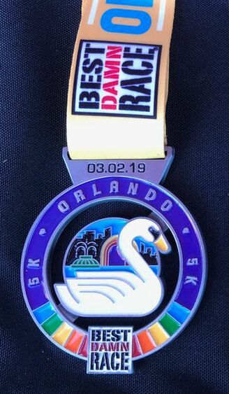 Swan on 5K Best Damn Race Orlando medal