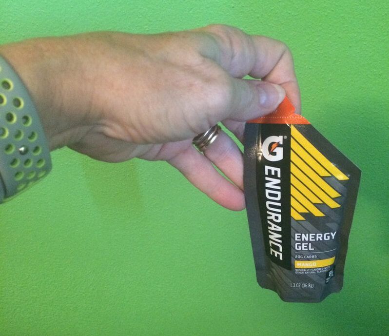 Hand holding a Gatorade Endurance gel in mango flavor.