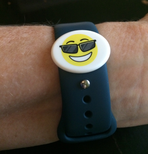 Smiley face sunglasses emoji bib board attached to a watch.