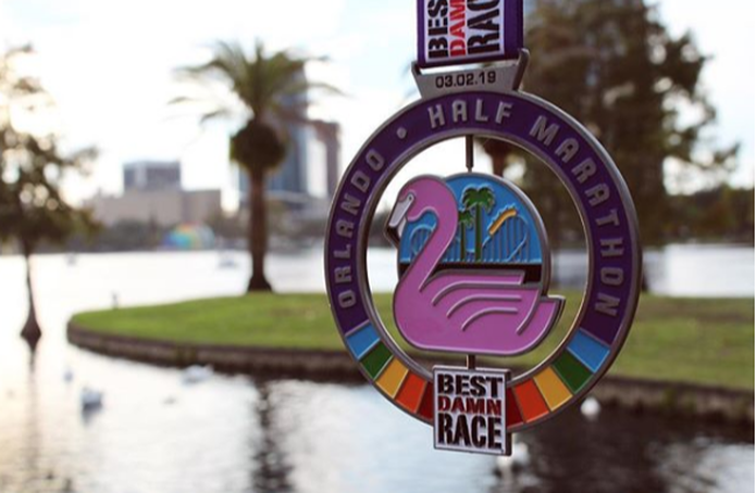 Photograph of Best Damn Race Orlando Half Marathon spinner medal