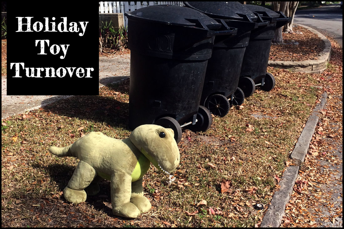 #seenonarun Stuffed animal dinosaur standing next to garbage dumpsters.