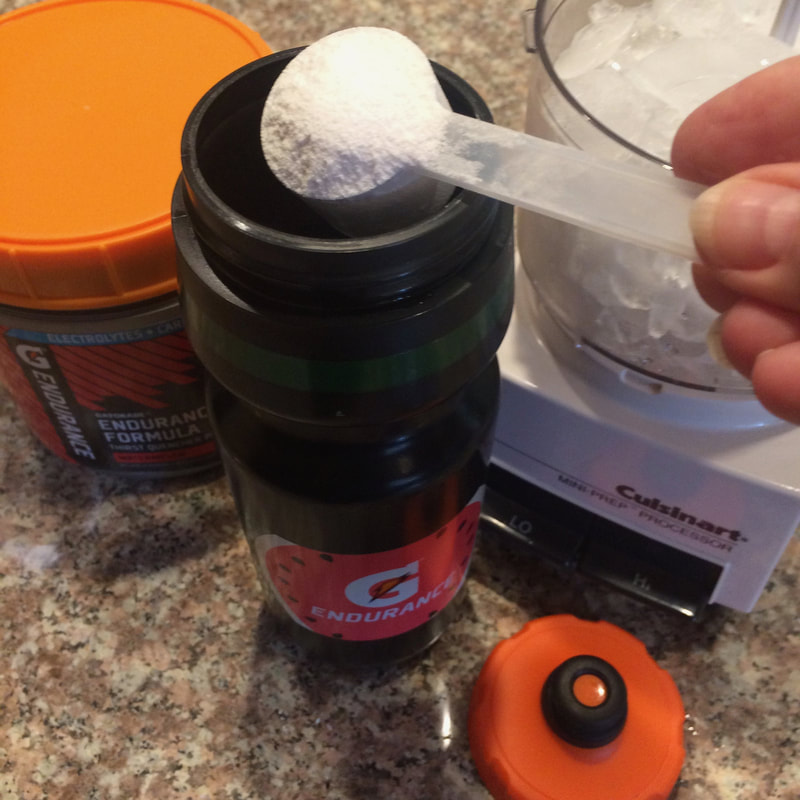 Pouring Gatorade powder into hydration bottle
