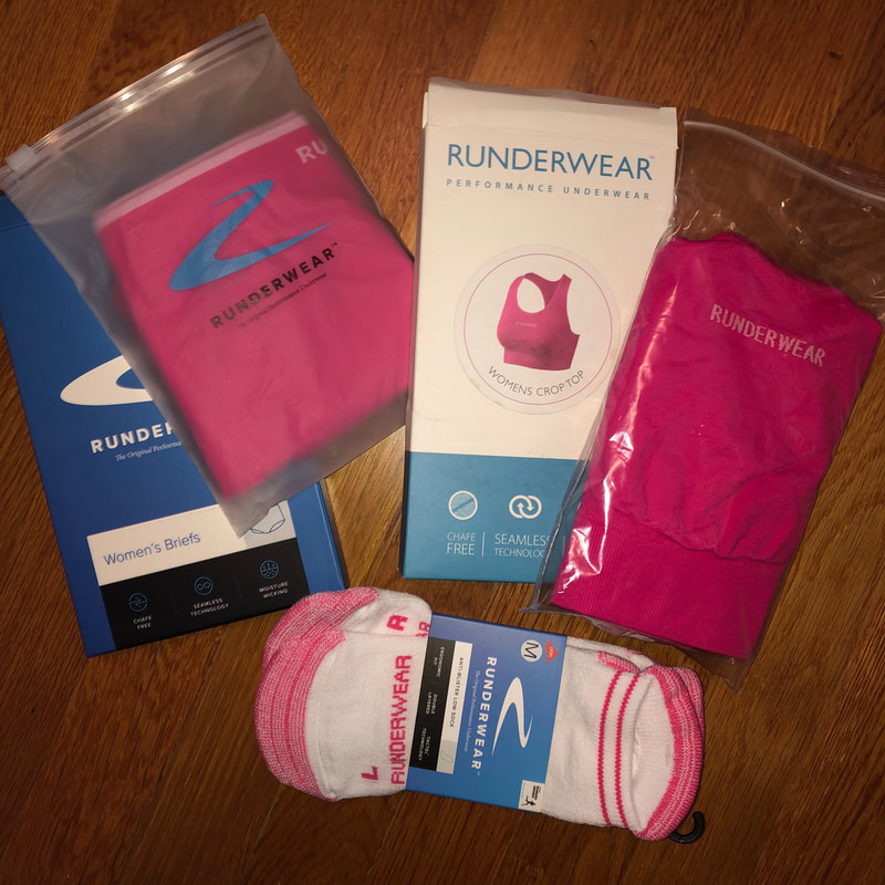 Photo of pink Runderwear Briefs, Crop Top, and Anti-blister socks.