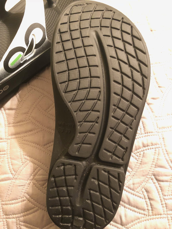 Sole showing tread on Oofos sandals.