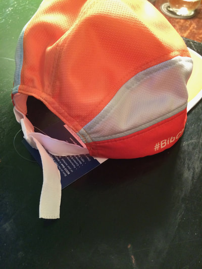 Boco Gear performance hat in orange and white.