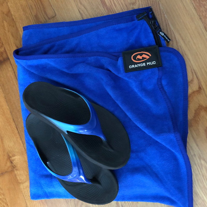 Orange Mud transition wrap in royal blue and matching Oofos recovery sandals.