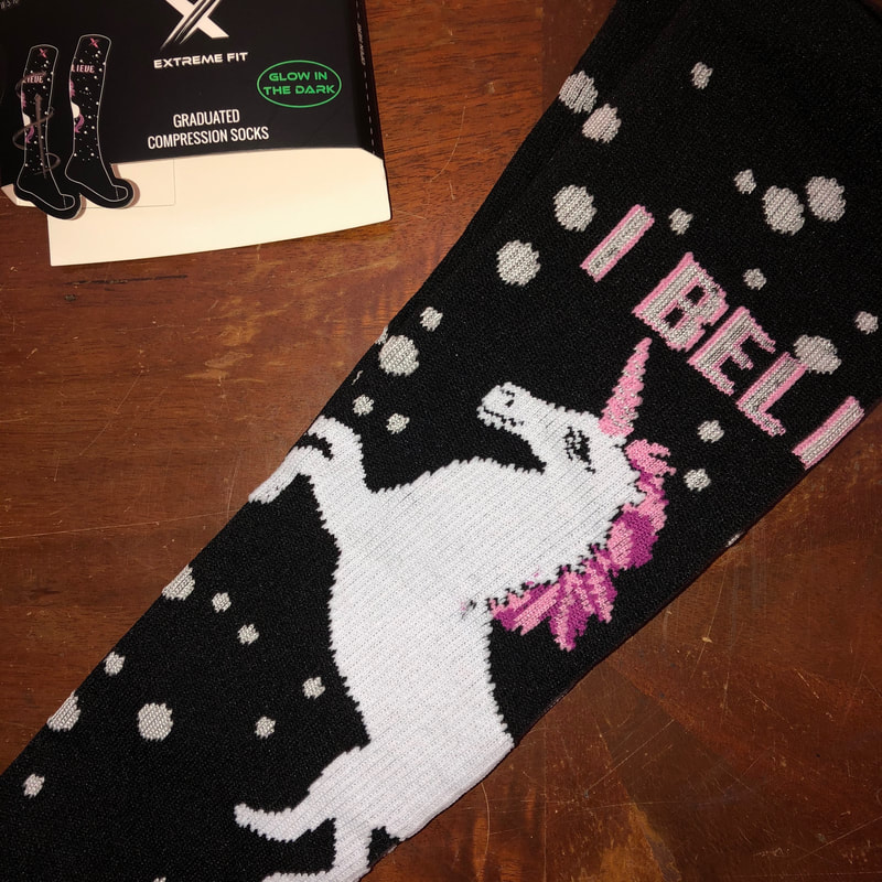 Close up image of unicorn glow in the dark compression sock.
