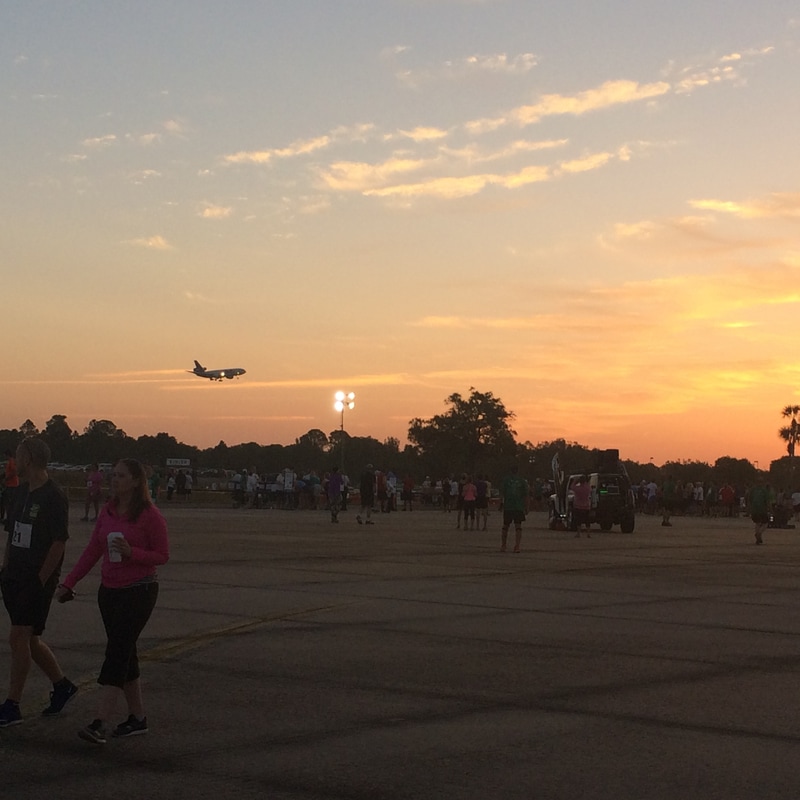 A plane lands at TIA before the 5K on the Runway race.