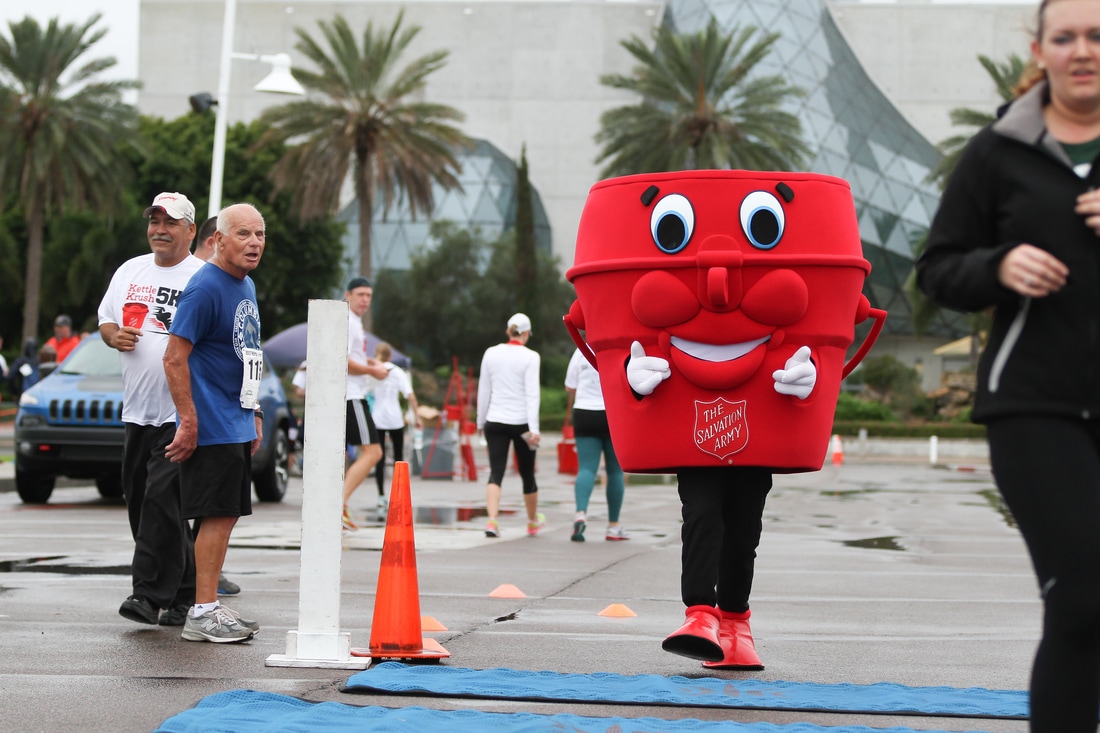 The Salvation Army Red Kettle mascot crosses the finish line of the 2017 Kettle Krush 5K.