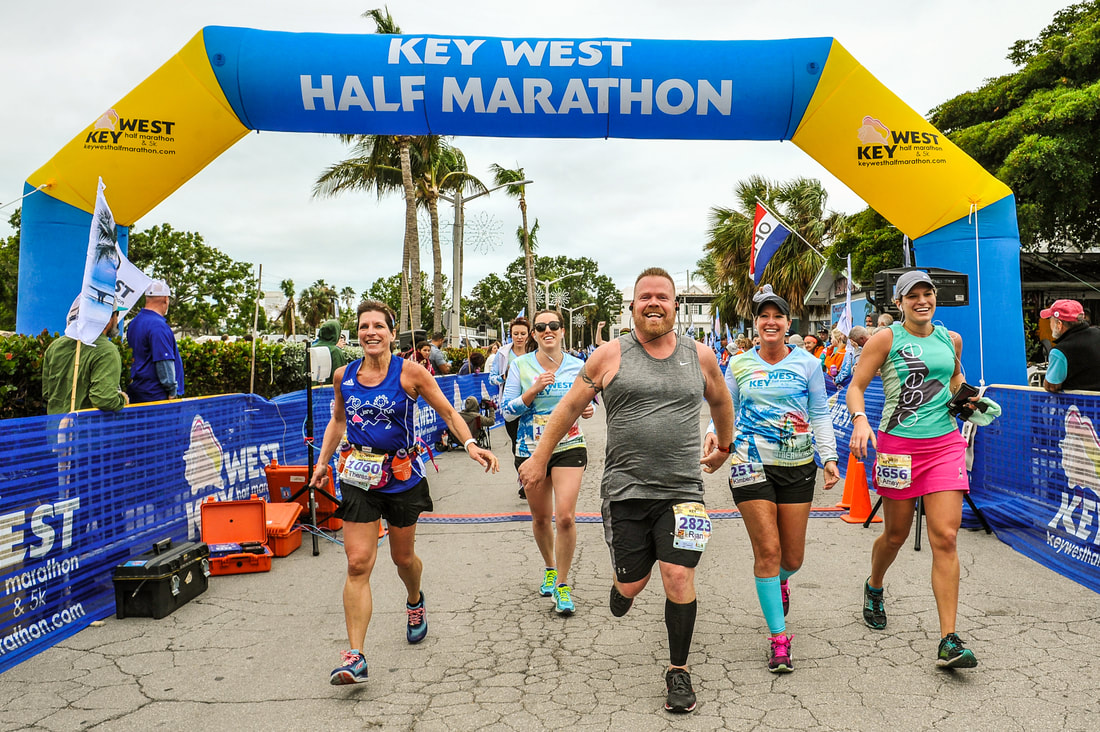 Racers cross the finish line at the Key West Half Marathon.
