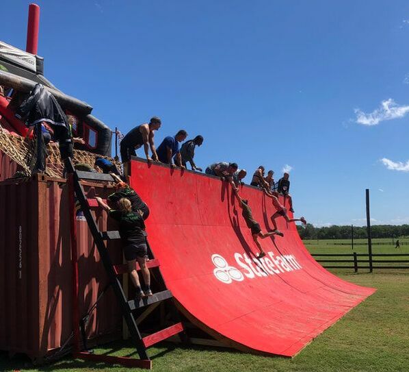 Warped Wall obstacle at Rugged Maniac event.