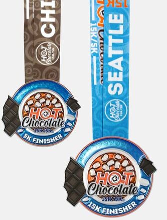 New Hot Chocolate 15K and 5K medals are colorful renditions of hot chocolate in a cup.