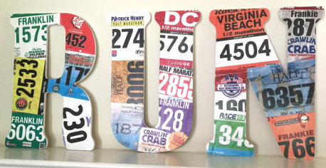 Race bibs glued to wooden letters.