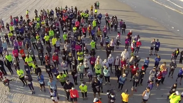 Runners at starting line of Race for the Cupcake 5K on the beach.