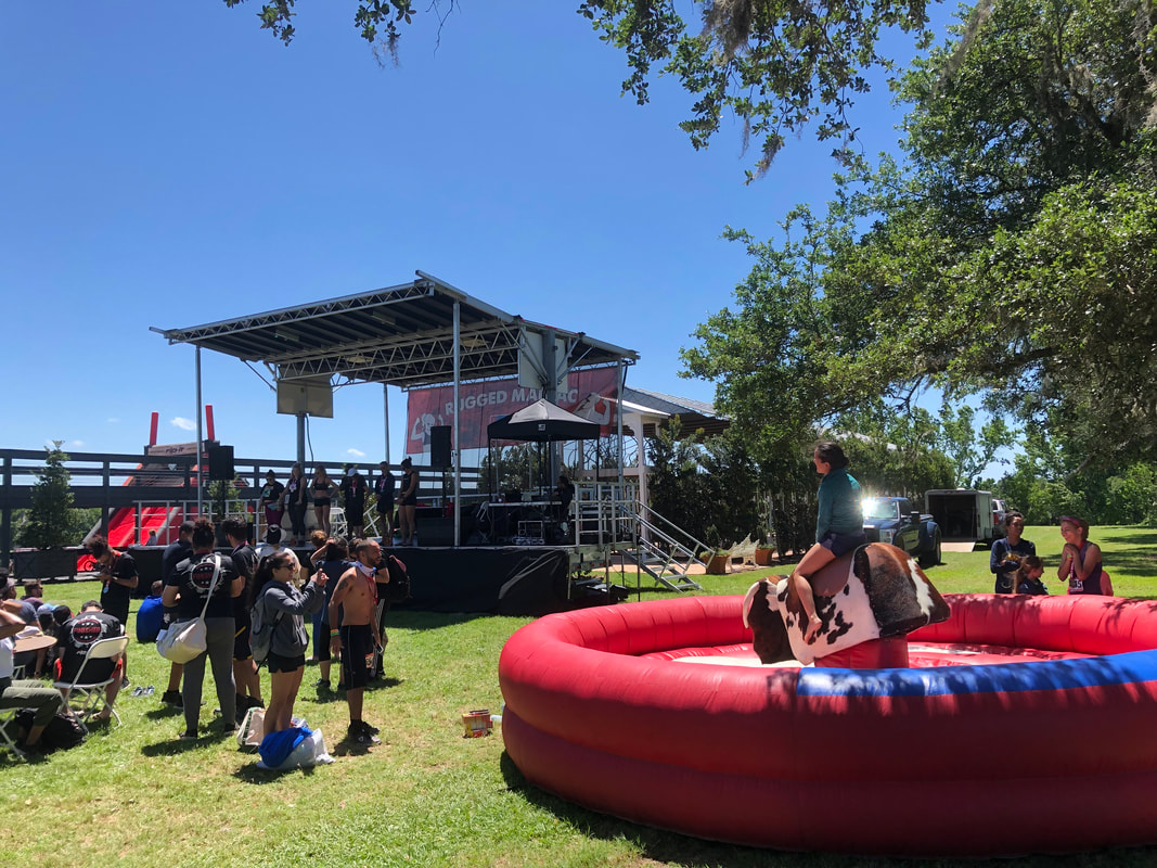 Stage and mechanical bull riding at Rugged Maniac event.