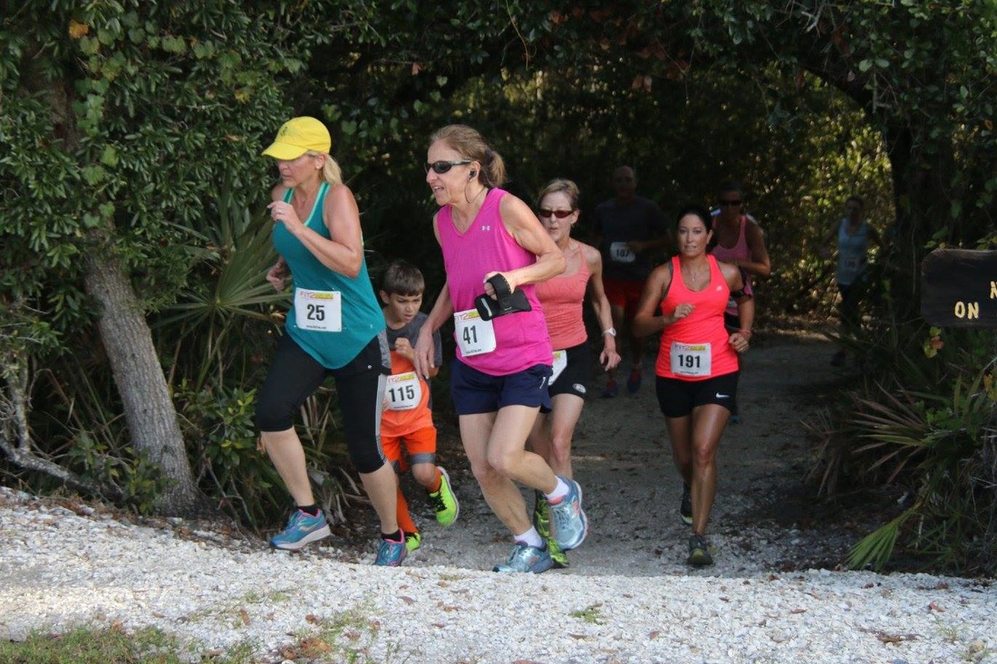 Runners exit the Mangrove Tunnel at Weedon Island Preserve